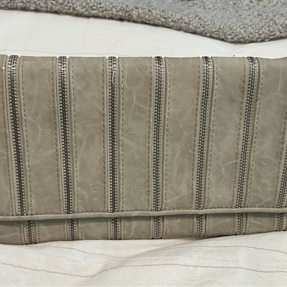 Light grey vegan leather clutch with silver zipper detail.